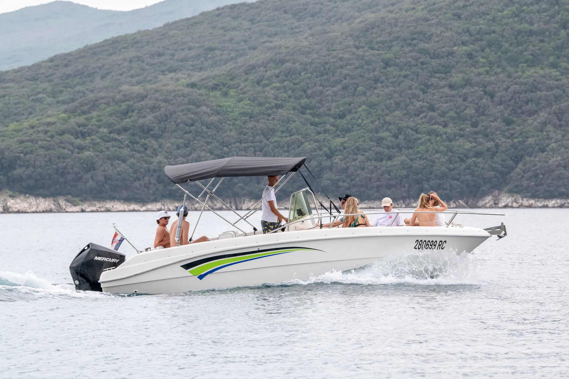 FIART OASSI 22 at cruising speed — guests aboard, Istrian shore behind.
