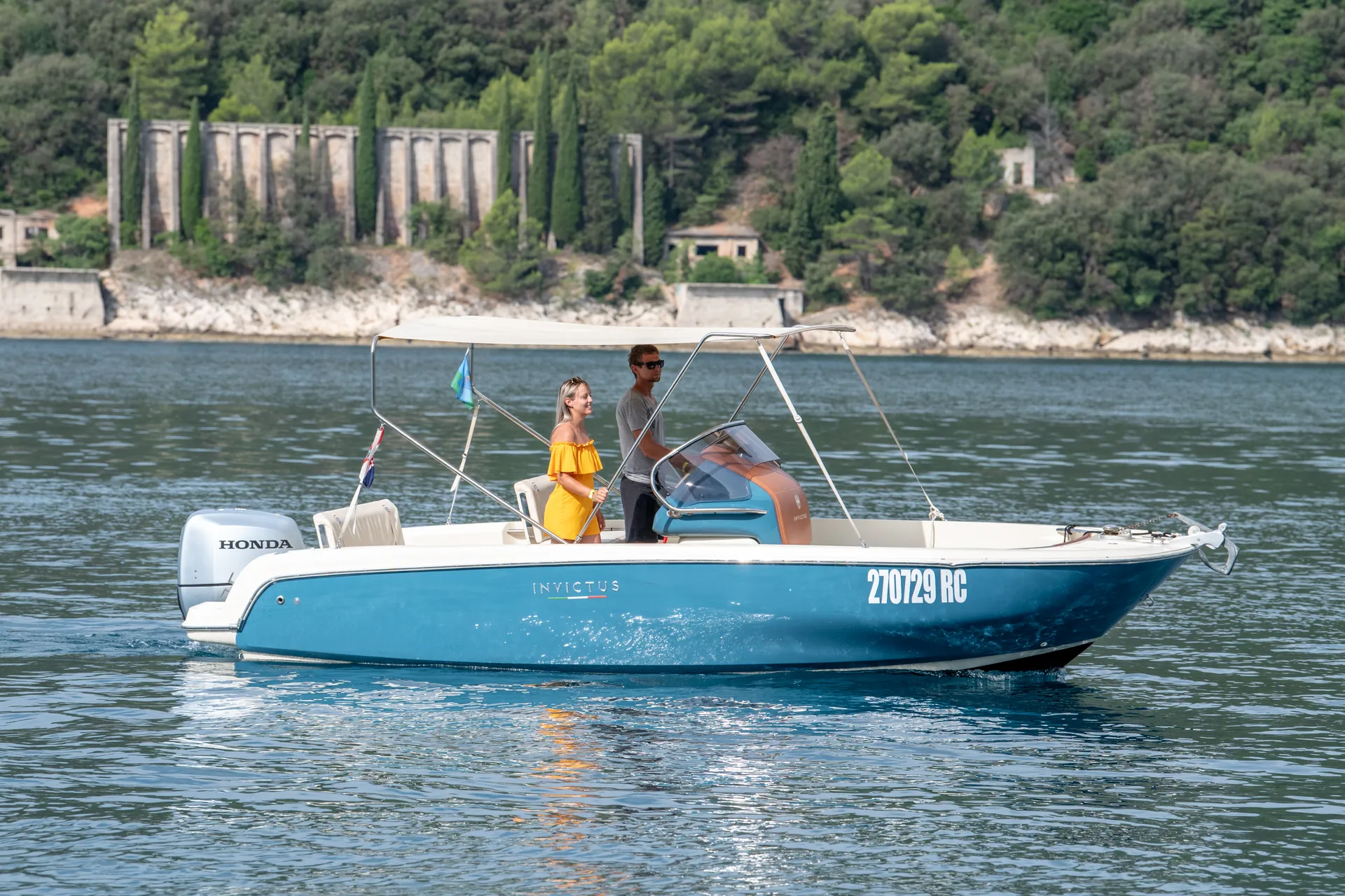 Invictus speedboat — Italian lines, blue hull, calm anchorage off Rabac.