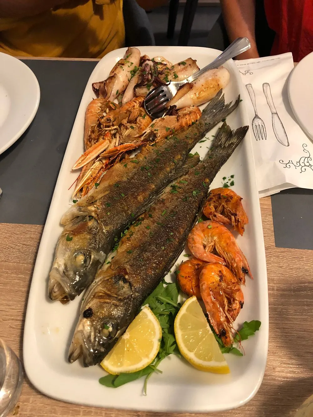 Fresh fish menu display at Konoba Porat, Plomin Luka — the day's catch presented to guests.